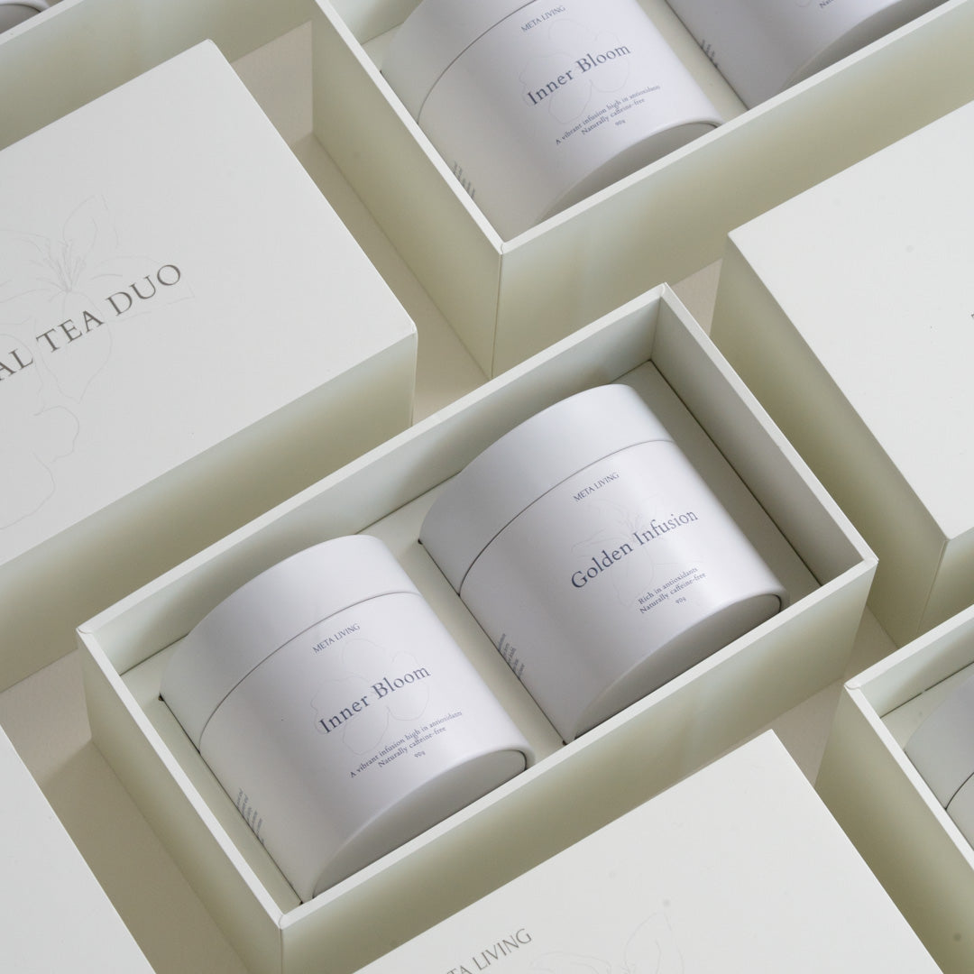 The Floral Tea Duo Set packaging close up showing the tin in gift packaging. Showing Inner Bloom and Golden Infusion Tea. 