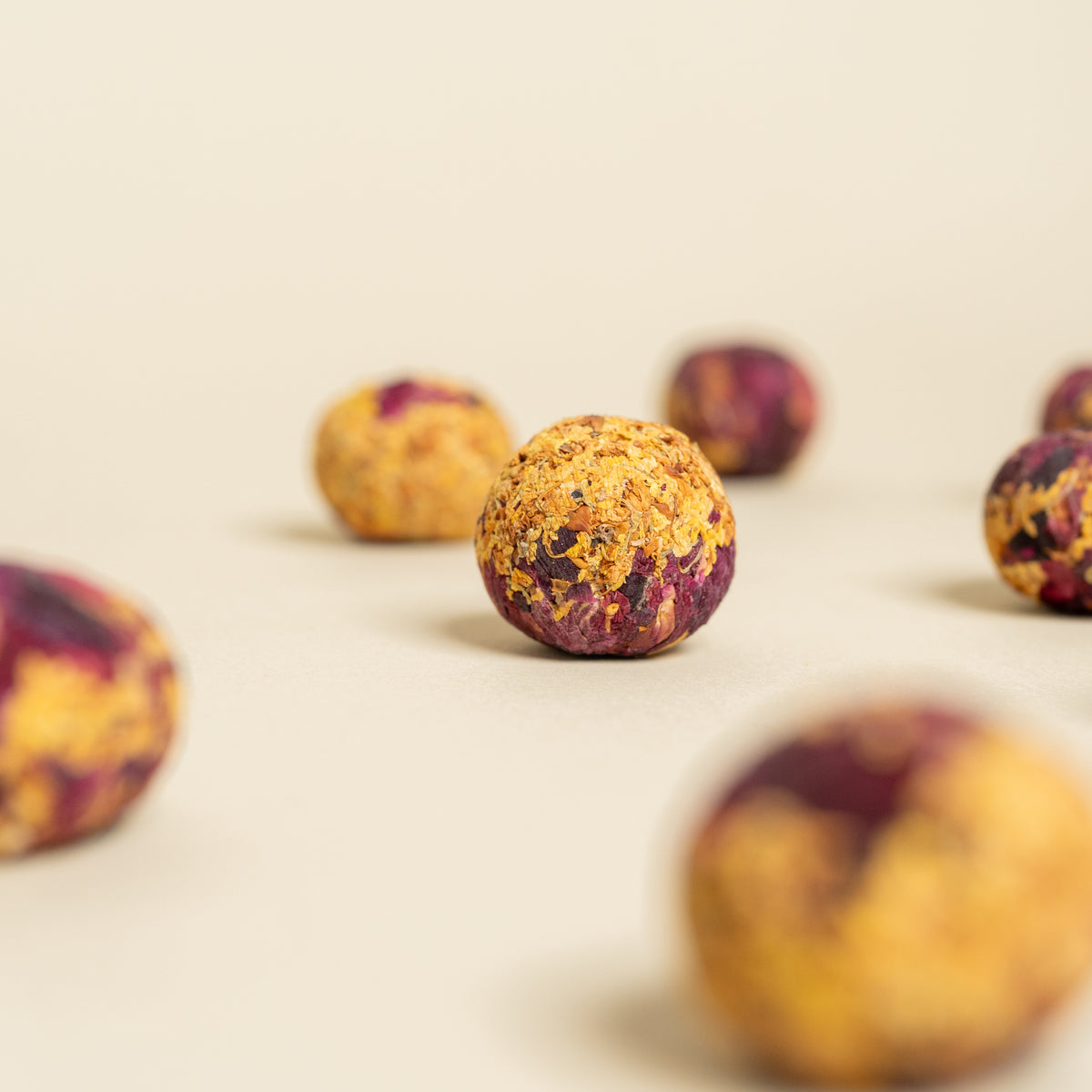 Evening Glow tea ball close up showing osmanthus and rose pressed into a ball