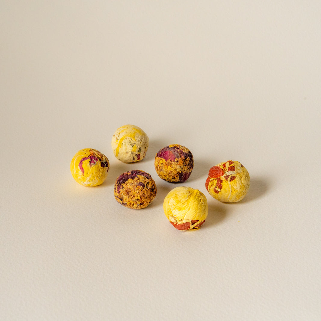close up shot of floral tea balls. evening rose, golden infusion and inner bloom tea