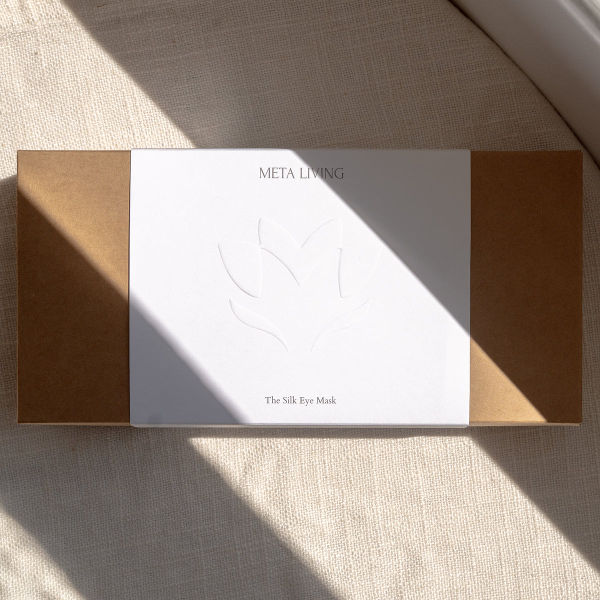 the silk eye mask packaging box in sunlight and linen background